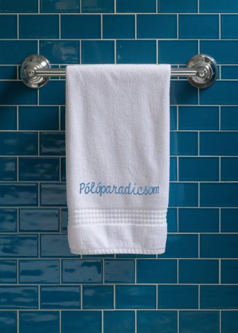 Modern bathroom towel dryer on a white wall background