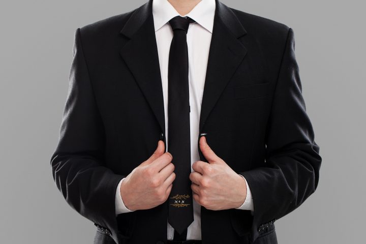 Businessman's torso in suit over grey background