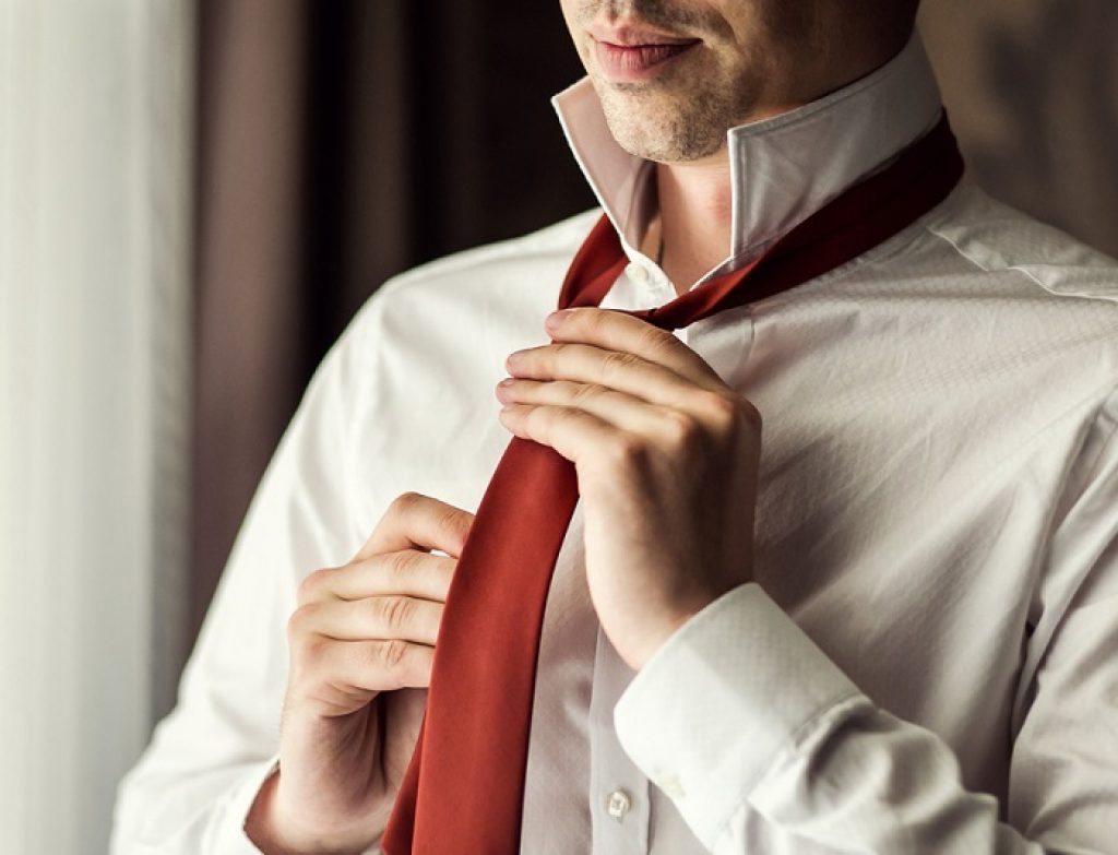 Man,In,Shirt,Dressing,Up,And,Adjusting,Tie,On,Neck