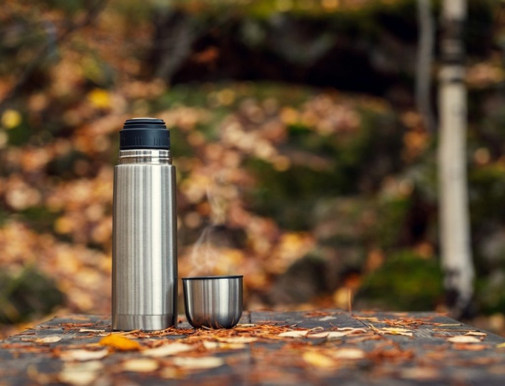 Steel,Thermos,With,Delicious,Hot,Tea,In,The,Autumn,Forest