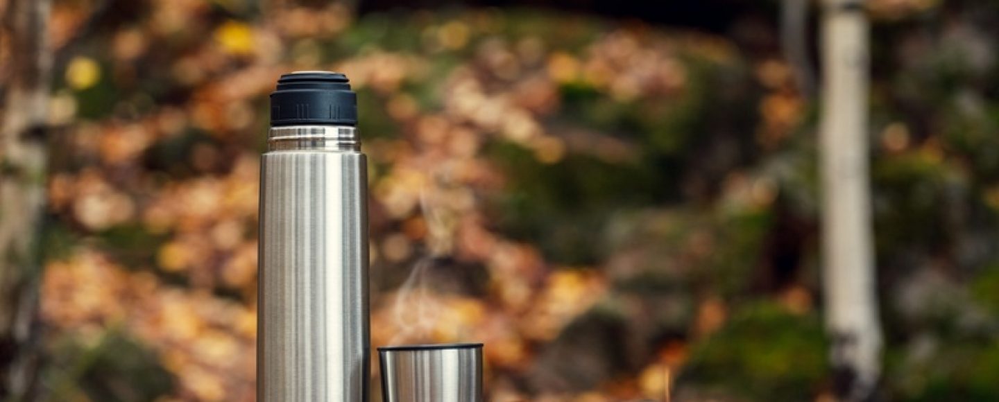 Steel,Thermos,With,Delicious,Hot,Tea,In,The,Autumn,Forest